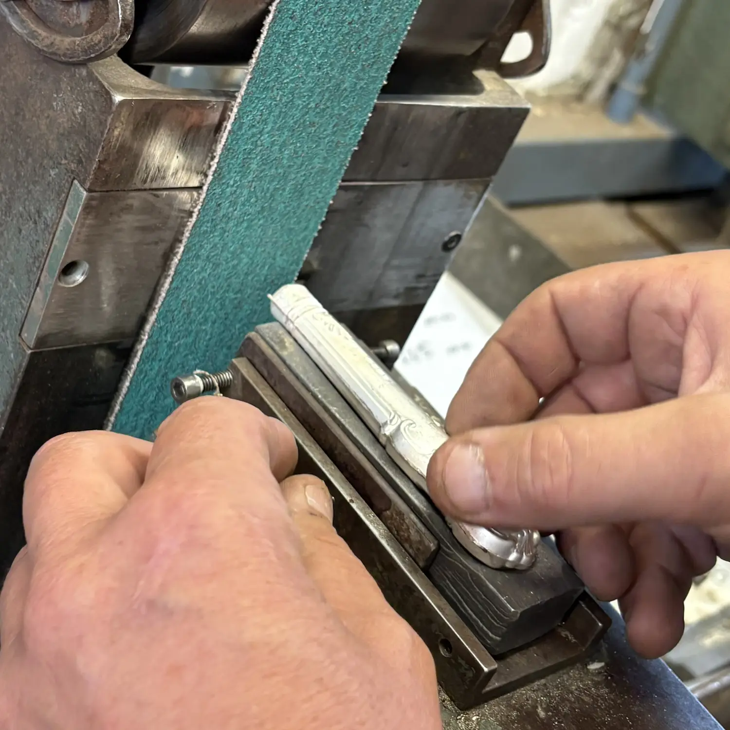 Hand finishing a silver-handled knife